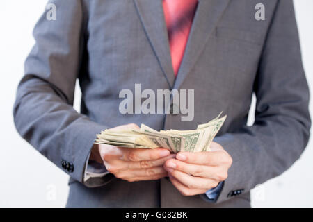 Businessman counting bill notes in white isolated background Stock Photo