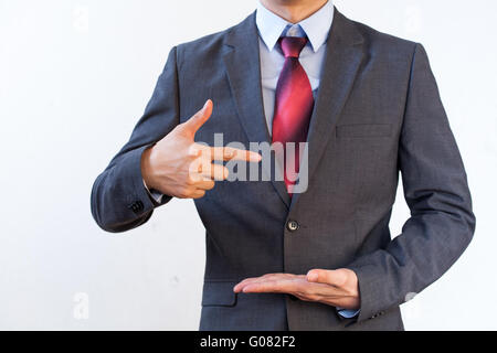 Businessman presenting something on white isolated background Stock Photo