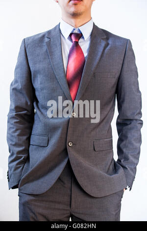 Business man holding his hands in pocket on white isolated background Stock Photo