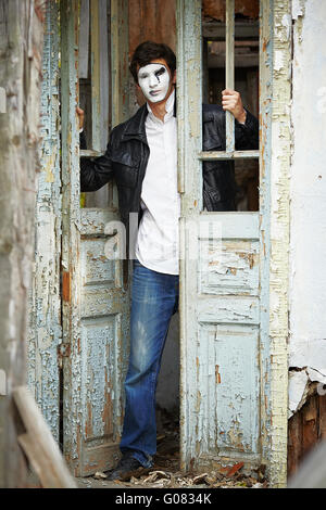 Guy mime against the old wooden door. Stock Photo