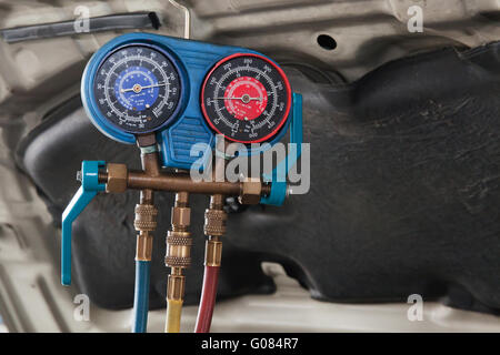 Monitoring tools for automotive air conditioning in car garage. Stock Photo