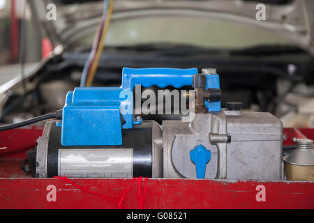 Monitoring tools for automotive air conditioning in car garage. Stock Photo