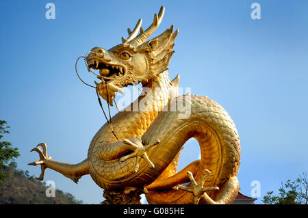 Golden dragon over blue sky. Phuket Stock Photo