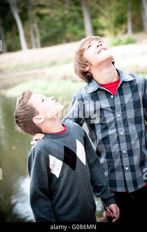 Two young boys looking up Stock Photo