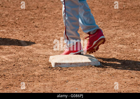 Baseball teen on base Stock Photo