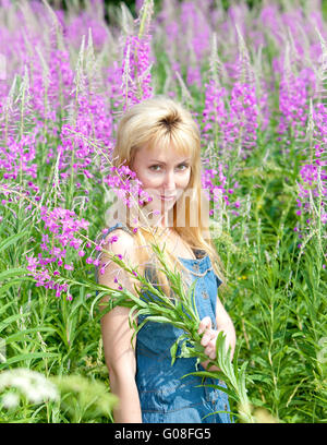 woman with bouquet of firetop flower in the field Stock Photo