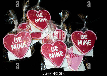 Red Be Mine heart shaped Valentine cookies on sale at grocery store checkout. St Paul Minnesota MN USA Stock Photo