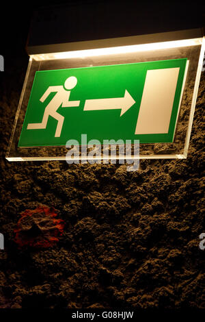 Lighted emergency exit sign. Stock Photo