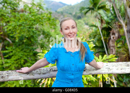Cuba. The beautiful woman in a  blue dress in park Stock Photo