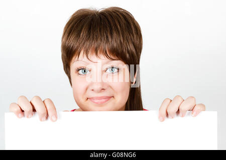 Young girl looking from behind a white sheet Stock Photo