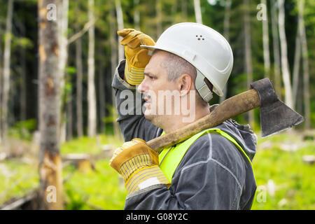 Lumberjack in the forest with an ax Stock Photo