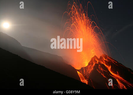 Volcano Stromboli erupting in a full moon night Stock Photo