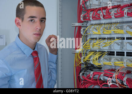 young it engineer in network server room Stock Photo
