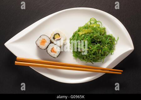 Seaweed Salad with Maki Sushi and Chopsticks Stock Photo