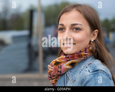 portrait of a beautiful girl in a denim jacket with a scarf Stock Photo