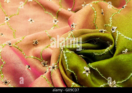 Pink and green satin textile background (close up) Stock Photo