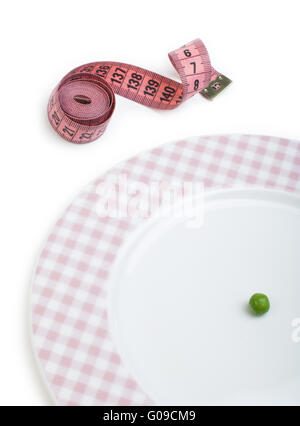 Plate with one peas. Dumbbell and centimeter measure. Stock Photo