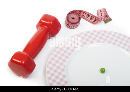 Plate with one peas. Dumbbell and centimeter measure. Stock Photo