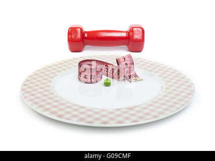 Plate with one peas. Dumbbell and centimeter measure. Stock Photo