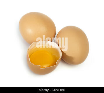 Tree whole eggs and another broken in half raw egg Stock Photo