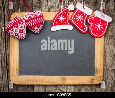 Christmas tree decorations on vintage wooden blackboard Stock Photo
