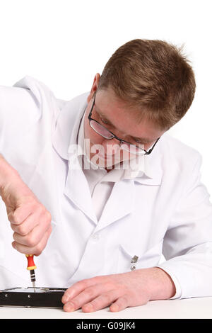 a man with a screwdriver disassembles a computer hard drive Stock Photo