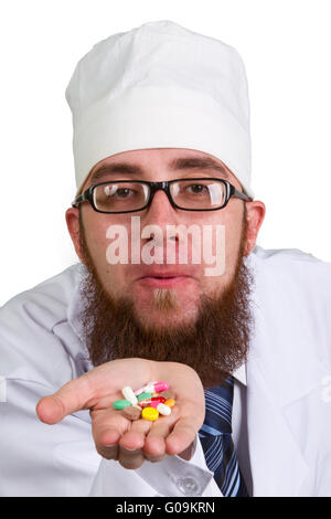 thoughtful male doctor holding a pill on white background Stock Photo