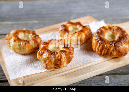 Soft newly-baked rolls on an old kitchen table Stock Photo