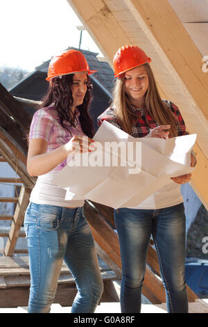 Two young women workers on the roof Stock Photo