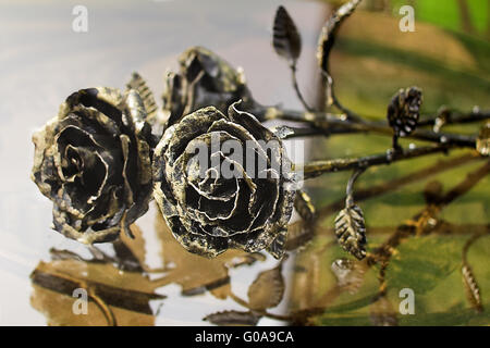 The shiny metal forged roses, handmade Stock Photo