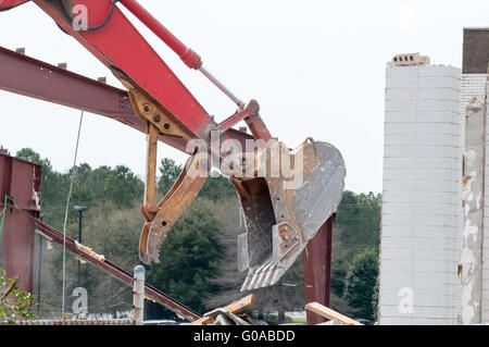 wreck excavator at work demolishing a building wall Stock Photo