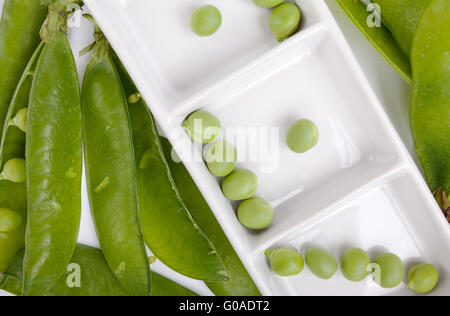 Fresh and dried Peas on white Background Stock Photo