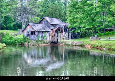 Historic Edwin B. Mabry Grist Mill (Mabry Mill) in rural Virginia on Blue Ridge Parkway and reflection on pond in summer Stock Photo