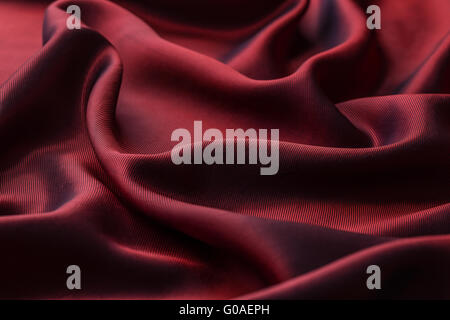 Red texture, wavy glossy silk drapery Stock Photo