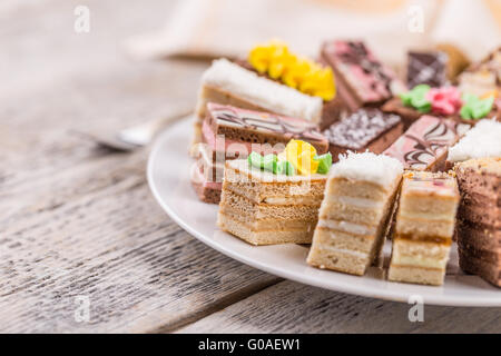 Small colorful sweet cakes on white plate Stock Photo