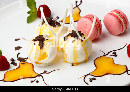 Pink macaroons with vanilla ice cream and honey Stock Photo