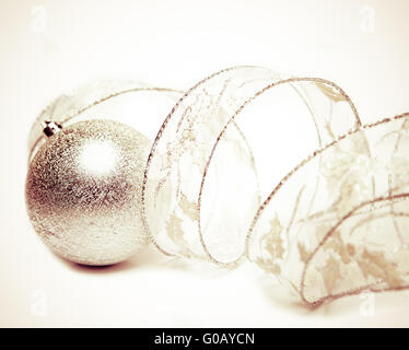 Beautiful silvery New Year's ball and elegant tins Stock Photo