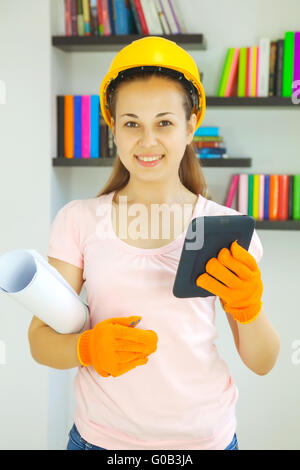 Young attractive lady architect with blueprints Stock Photo