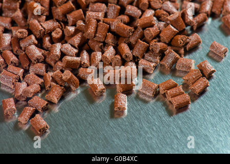 brown Ppolymer pellets on metal sheet Stock Photo