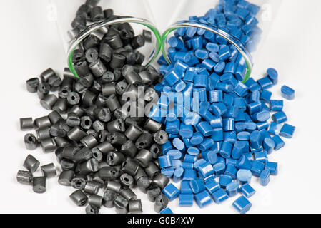 blue and black polymer pellets in test tubes Stock Photo