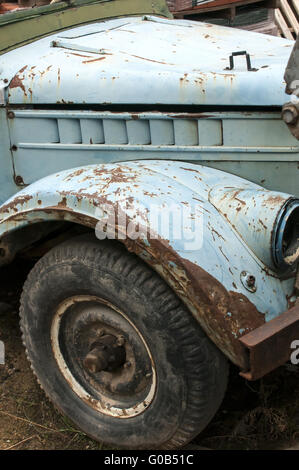 Wheel, rusty mud-guard and car hood of vintage car Stock Photo