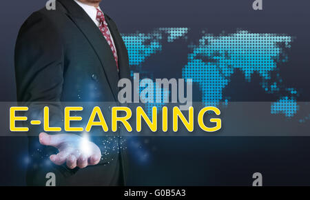 Business concept image of a businessman showing E-Learning word on his hand over blue background with dotted world map Stock Photo