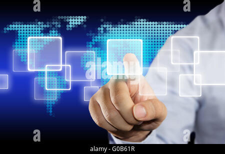 Business concept image of a businessman clicking icon button on virtual touchscreen over blue background with dotted world map Stock Photo