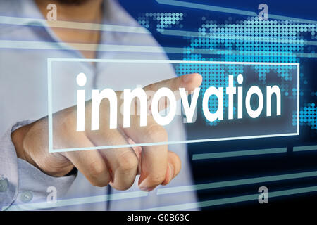 Businessman clicking Innovation word on virtual screen Stock Photo