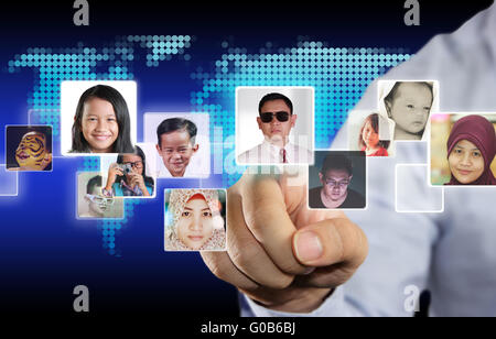 Internet Social Media Concept, image of a man clicking social media icons with people avatars in it over blue virtual screen Stock Photo