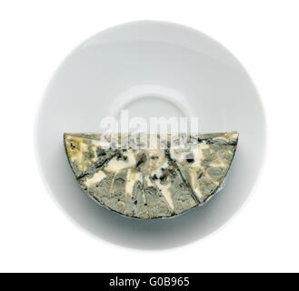 Cheese with black mold on the plate. View from above. Stock Photo
