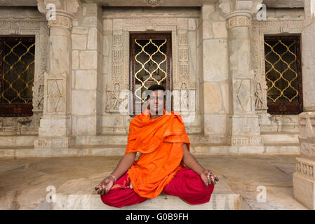 Priest in colourful robes at Jain temple at Ranakpur Stock Photo