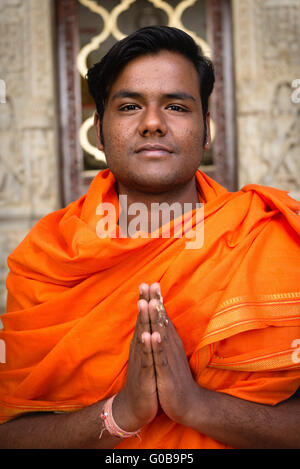 Priest in colourful robes at Jain temple at Ranakpur Stock Photo