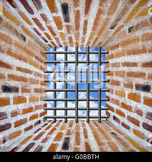 Prison's window and bars in wall from brick Stock Photo