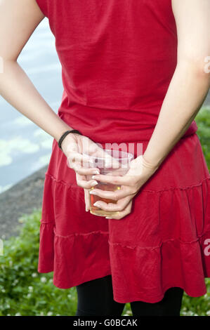 woman hiding beer Stock Photo